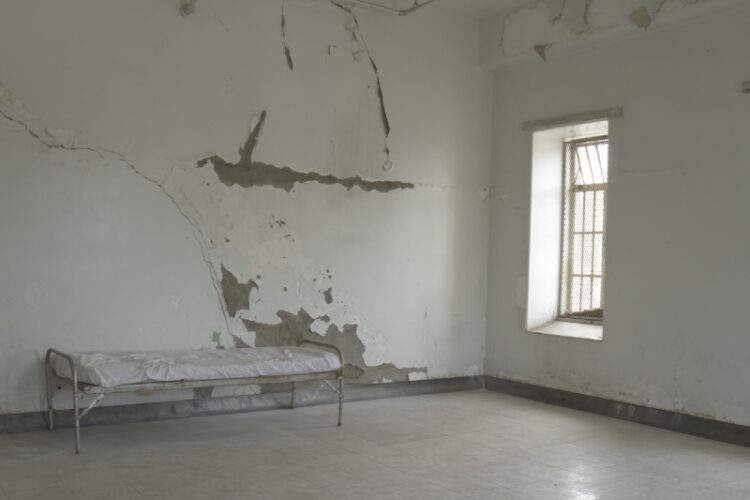 Cot in empty room
