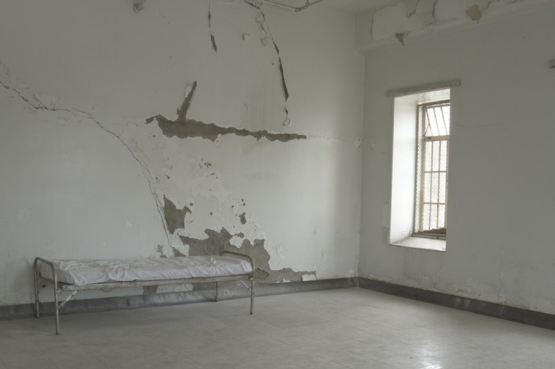 Cot in empty room