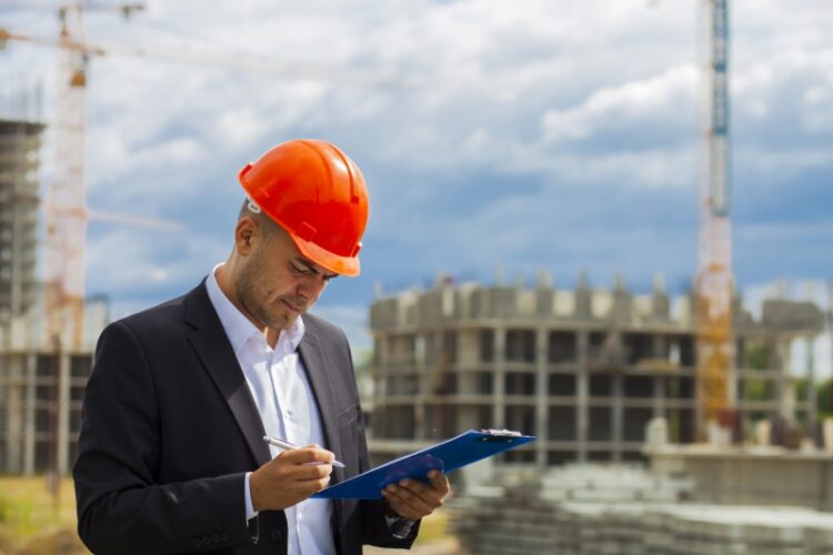 Worker inspector in helmet checking construction